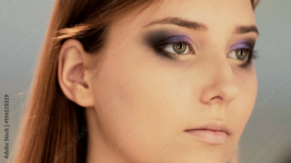 Makeup artist apply makeup to an attractive young woman. Makeup for young girl. Young girl in beauty salon. Makeup artist apply makeup to an attractive young woman. Makeup for young girl. Young girl in beauty salon.