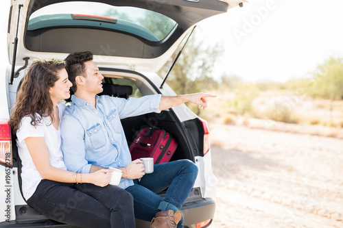Couple in car trunk looking at something interesting © AntonioDiaz