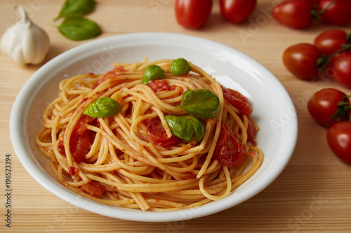 spaghetti with tomato sauce dish on a wood table
