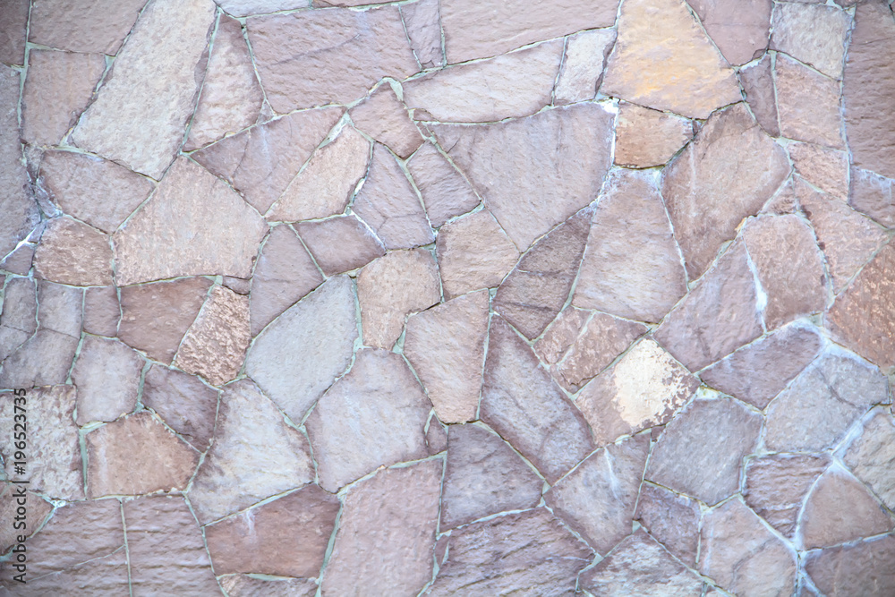 The texture of a beautiful fence with pieces of colored decorative stone. The texture of a beautiful fence with pieces of colored decorative stone.