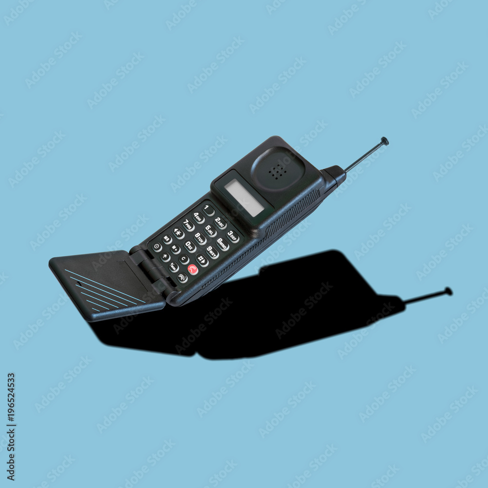 Vintage analog cellular phone with flip mouthpiece, dummy aerial and