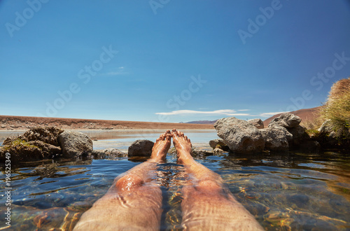 Man relaxing in water pool, low section, Salar de Chiguana, Chiguana, Potosi, Bolivia, South America photo