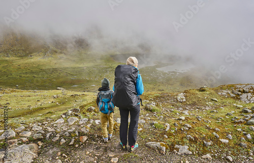 Mother and son, trekking through landscape, rear view, Ventilla, La Paz, Bolivia, South America