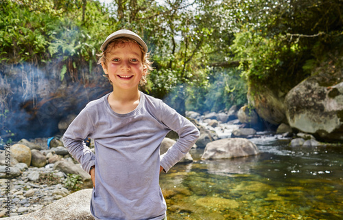 Portrait of boy beside water pool, Ventilla, La Paz, Bolivia, South America