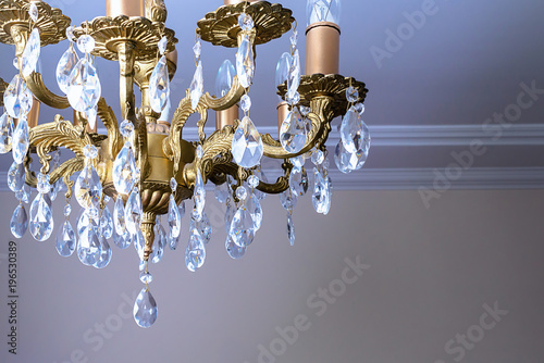 Crystal chandelier close-up. Gradient background © Maryana