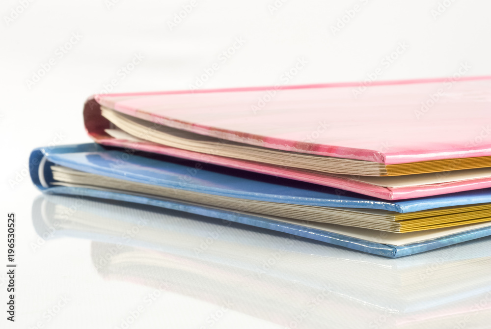 Closed photo albums on the table with reflection Closed photo albums on the table with reflection