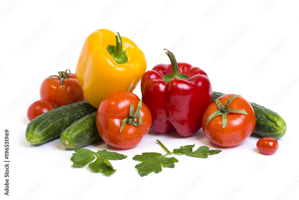 Red yellow and orange peppers with tomatoes on a white background. Cucumbers with colorful peppers in composition on a white background.. Red yellow and orange peppers with tomatoes on a white background. Cucumbers with colorful peppers in composition on a white background..