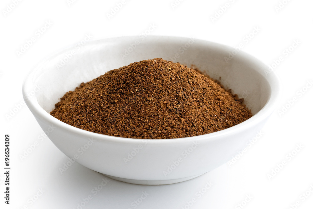 Ground cloves in white ceramic bowl isolated on white. Ground cloves in white ceramic bowl isolated on white.