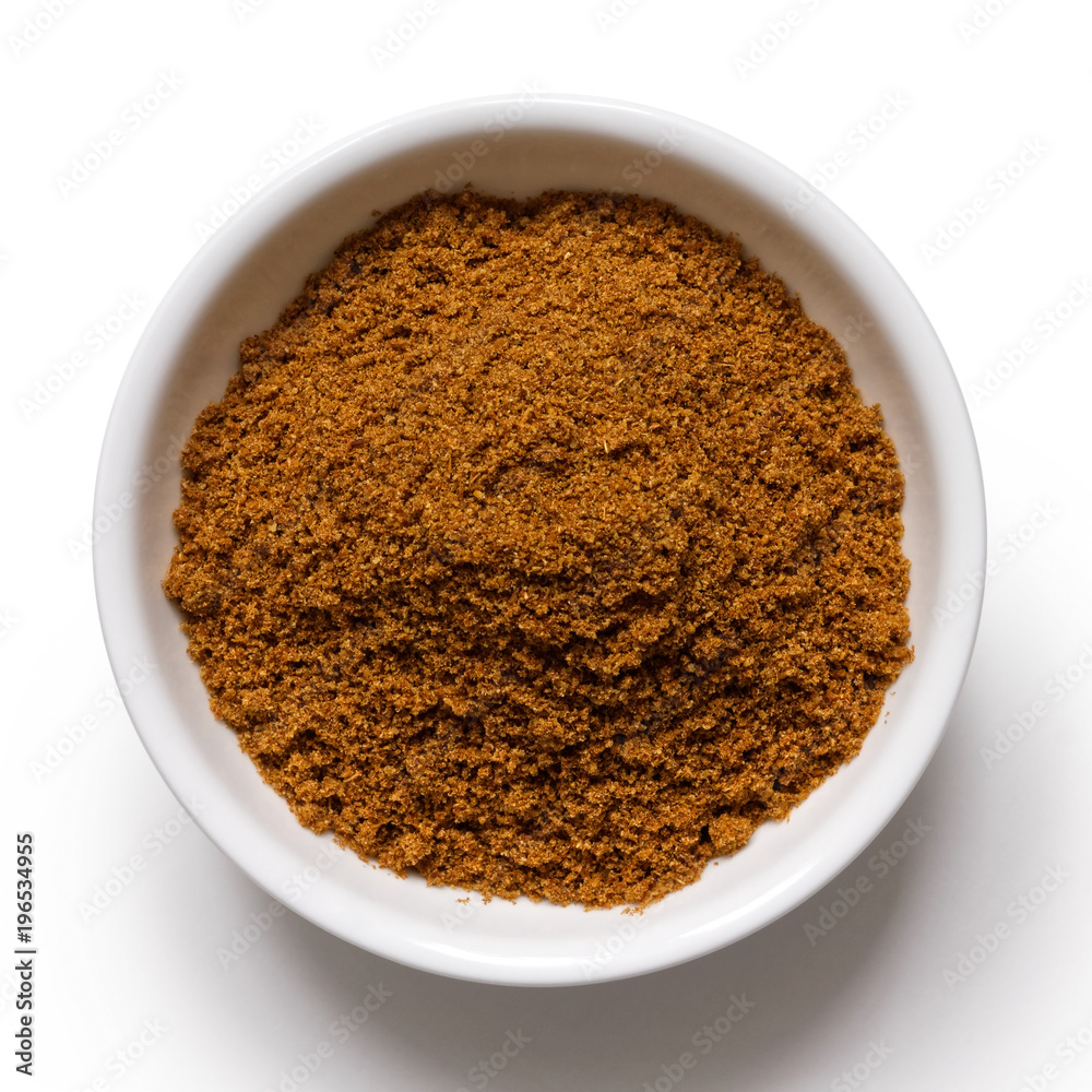 Ground cumin in white ceramic bowl isolated on white from above. Ground cumin in white ceramic bowl isolated on white from above.