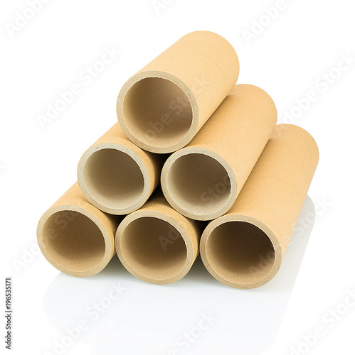 A bunch of brown industrial paper core isolated on white background with shadow reflection. A lot of paper cores or paper tubes on white backdrop. Brown paper rolls.