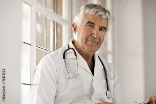 Portrait of a senior male doctor photo