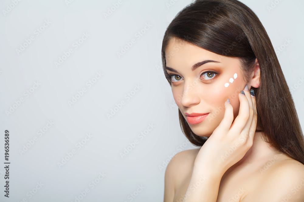 Beauty face of woman with cosmetic cream on face Beauty face of woman with cosmetic cream on face
