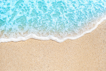 Summer background with Soft wave of blue ocean on sandy beach