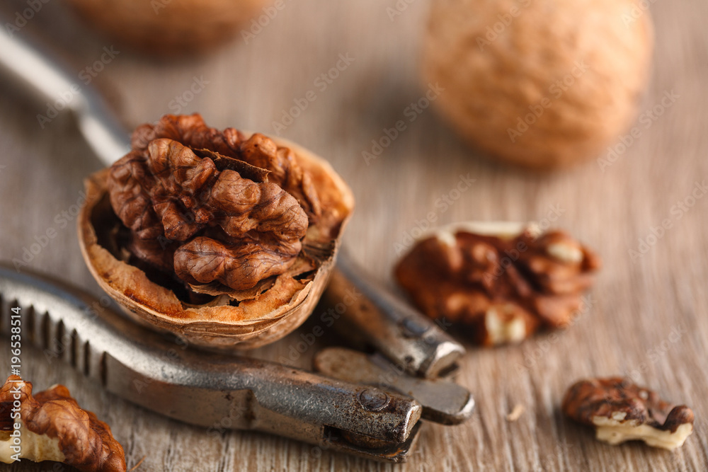 Walnut kernels and whole walnuts on rustic old wooden table. Walnut kernels and whole walnuts on rustic old wooden table.