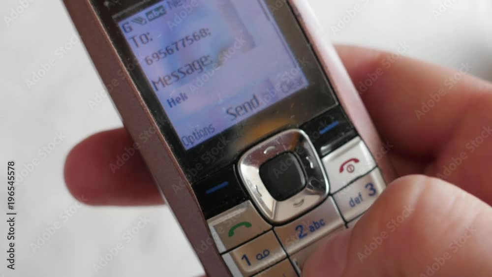 texting on outmoded, old school model of  mobile phone