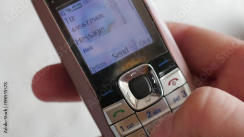 texting on outmoded, old school model of  mobile phone