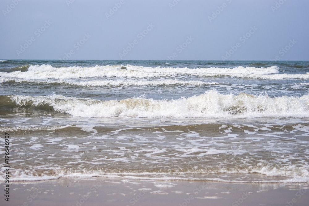 Baltic sea waves breaking on the sand beach