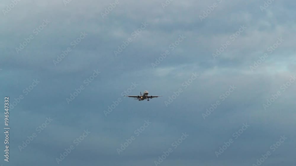 Long shot of an airplane flying, at dusk Long shot of an airplane flying, at dusk