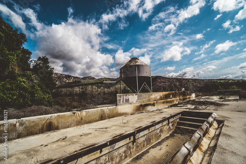 Abandoned and condemned farm with trough and water tower or silo