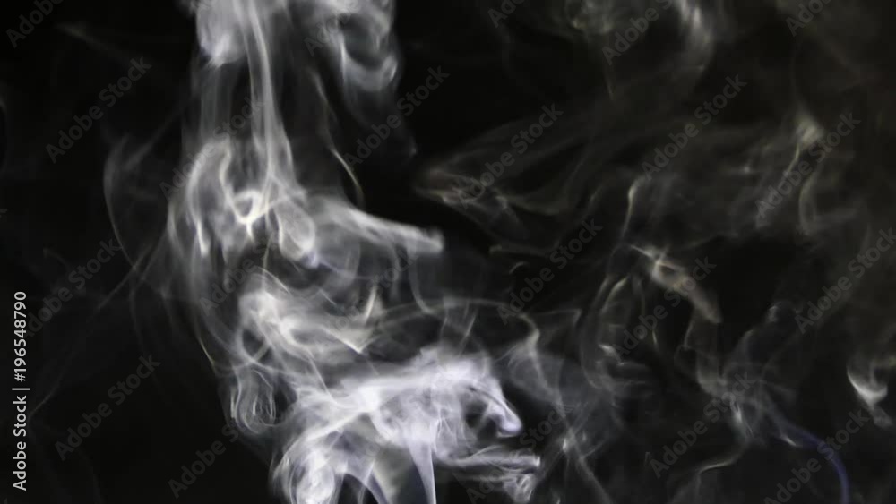 Beautiful gray smoke on a black background. Cigarette smoke. Smoke from the hookah. Turbulence of smoke. The white vapor rises. The smoke slowly flies. Beautiful gray smoke on a black background. Cigarette smoke. Smoke from the hookah. Turbulence of smoke. The white vapor rises. The smoke slowly flies.