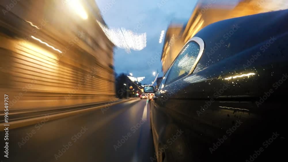 Hyperlapse from a moving car on a street at night with Christmas lights
