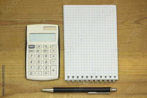 Top view office table calculator with pen on the table for business and copy space.