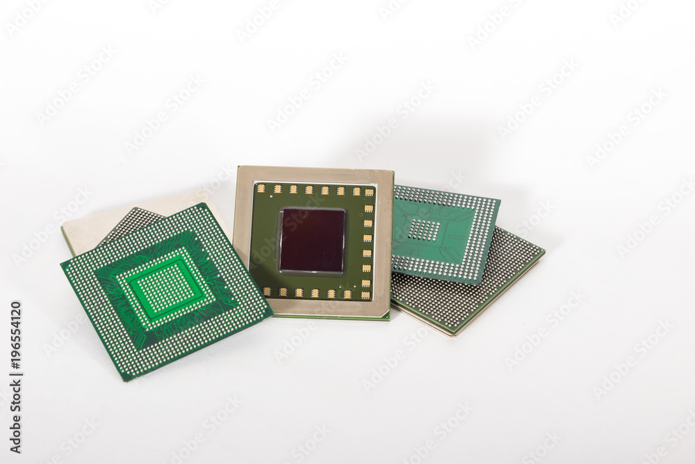 Computer electronic chips isolated on white arranged in a stack. The chips are placed upside down or facing the viewer. there are different chips in the stack Computer electronic chips isolated on white arranged in a stack. The chips are placed upside down or facing the viewer. there are different chips in the stack