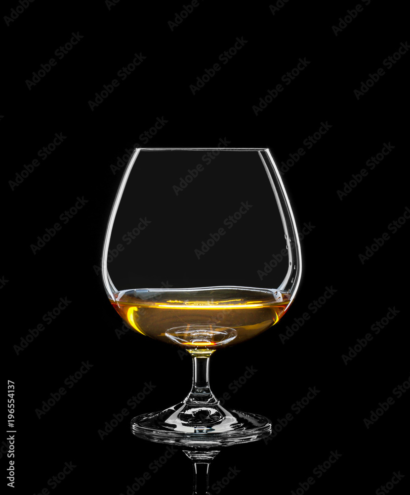 Cognac glass with drink on black Cognac glass with drink on black