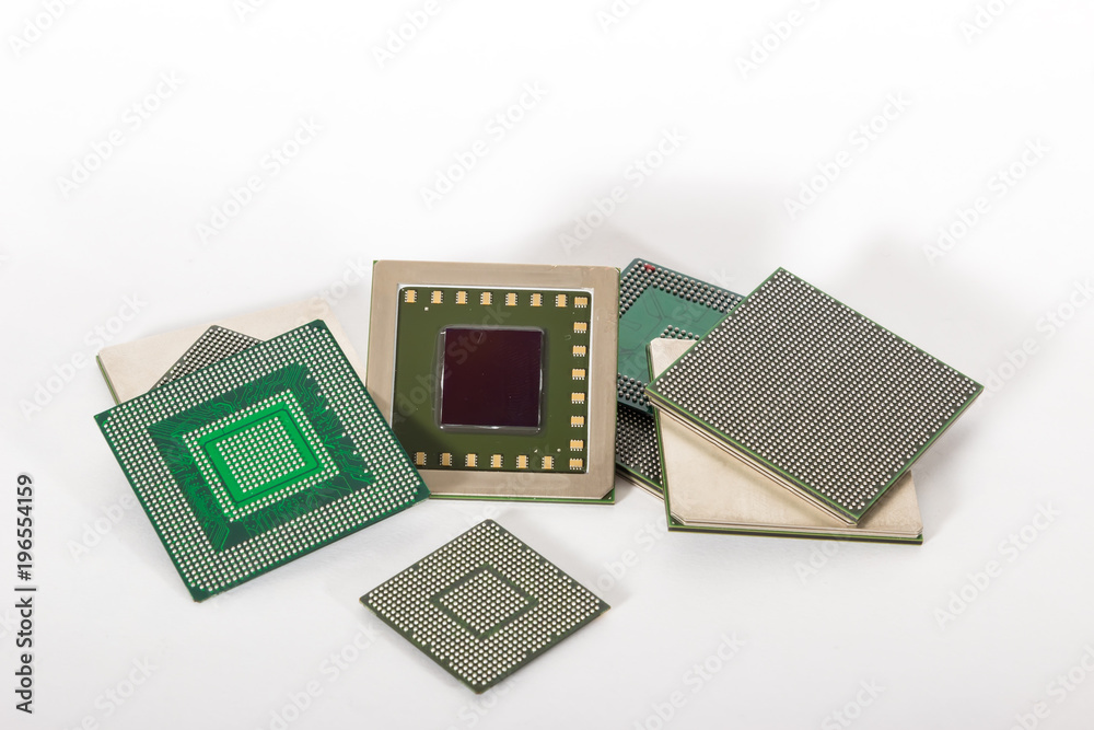 Computer electronic chips isolated on white arranged in a stack. The chips are placed upside down or facing the viewer. there are different chips in the stack Computer electronic chips isolated on white arranged in a stack. The chips are placed upside down or facing the viewer. there are different chips in the stack