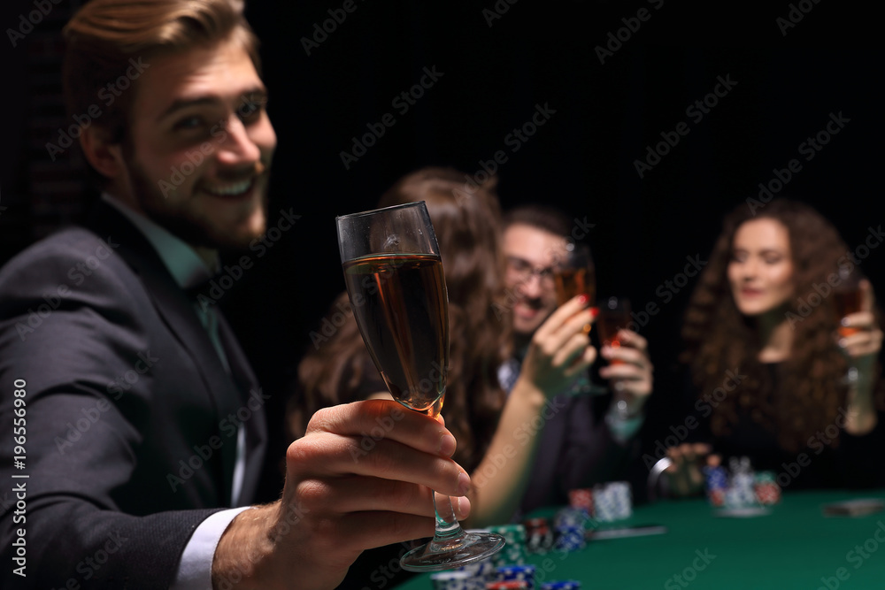 poker player with a glass of wine poker player with a glass of wine