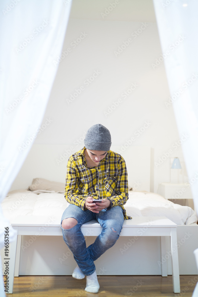 young boy with smartphone in the room