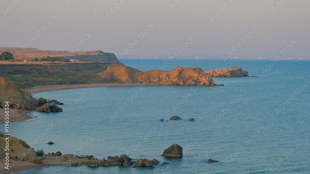 sea coast of Crimea with rocky shores and rocks in the Black Sea with beautiful turquoise water