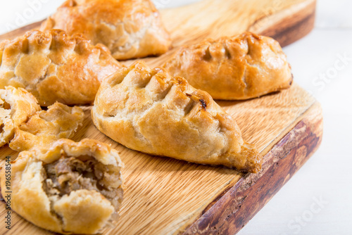 Hot pasties from butter enriched puff pastry filled with minced beef, potato, onions and swede
