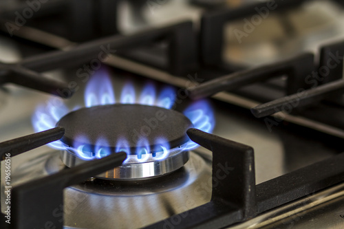 Fototapeta Natural gas burning on kitchen gas stove in the dark