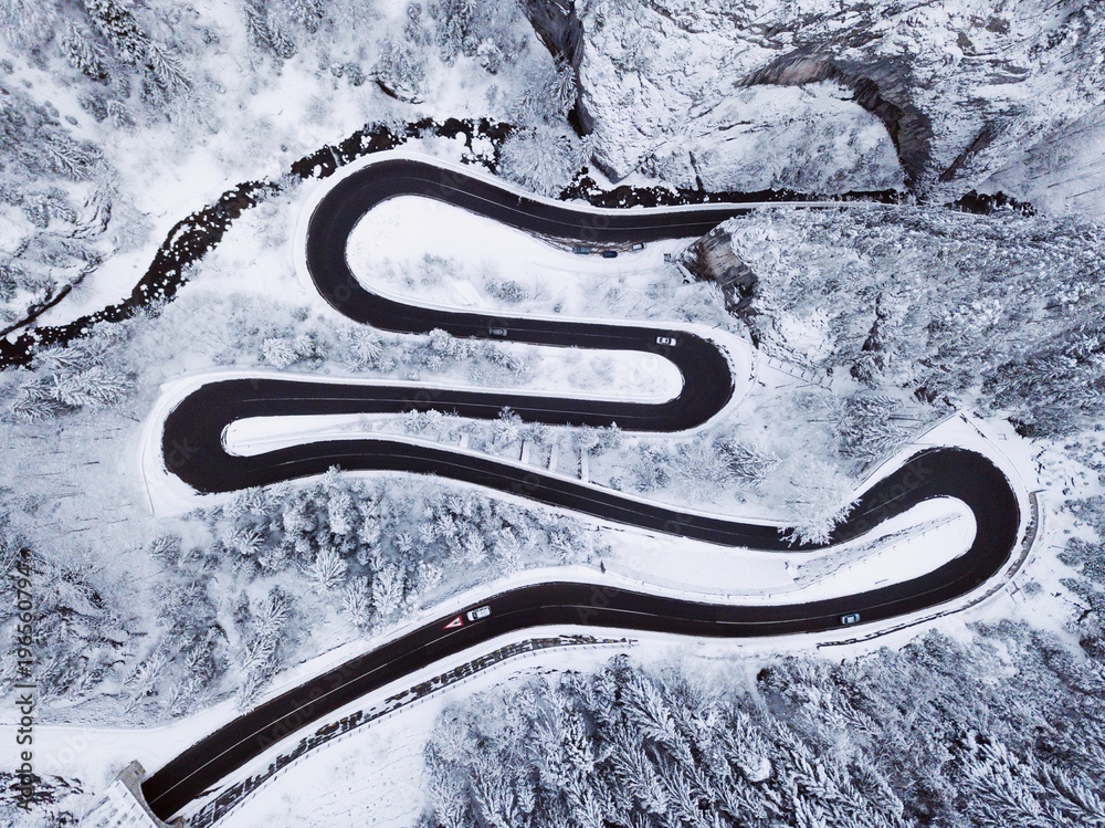 Beautiful winter aerial landscape.Snow covered trees and curved road.