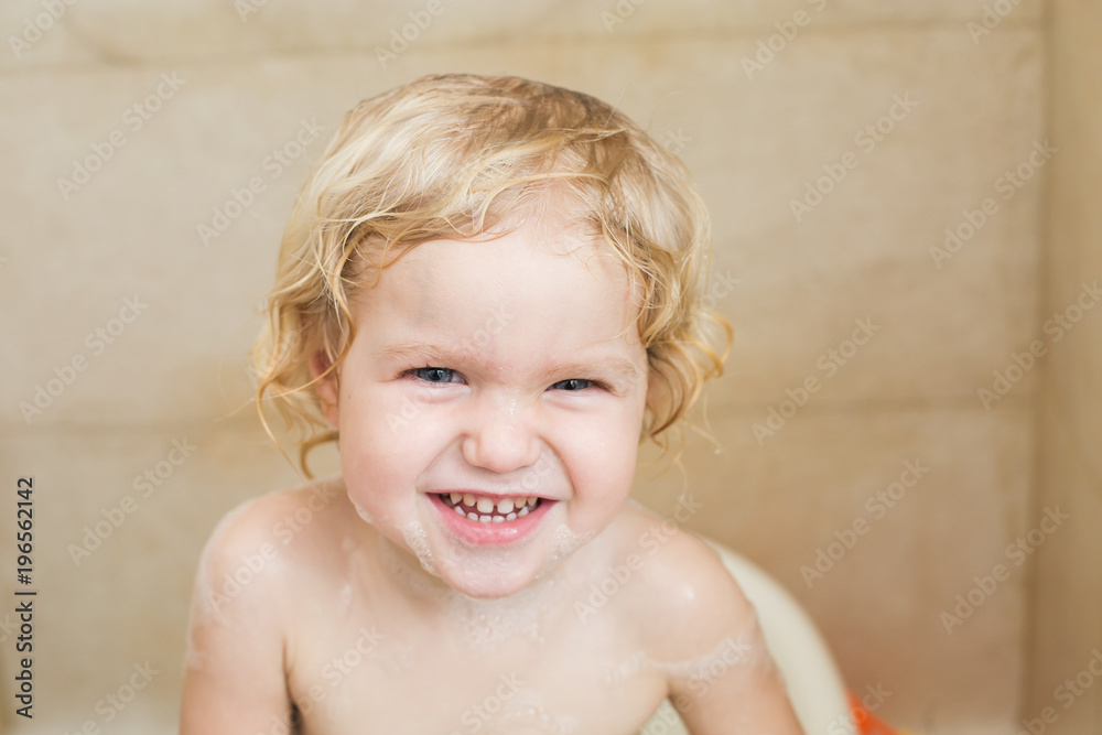 smiling child bathing in the bathroom with foam smiling child bathing in the bathroom with foam