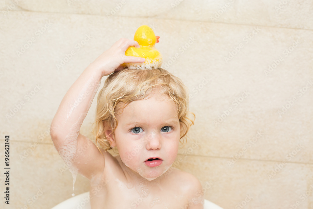 smiling child bathing in the bathroom with foam smiling child bathing in the bathroom with foam