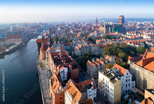Gdansk old city in Poland. Skyline with the oldest medieval port crane (Zuraw) in Europe, St Mary church, Town hall tower, Motlawa River and bridges. Aerial view in sunrise light