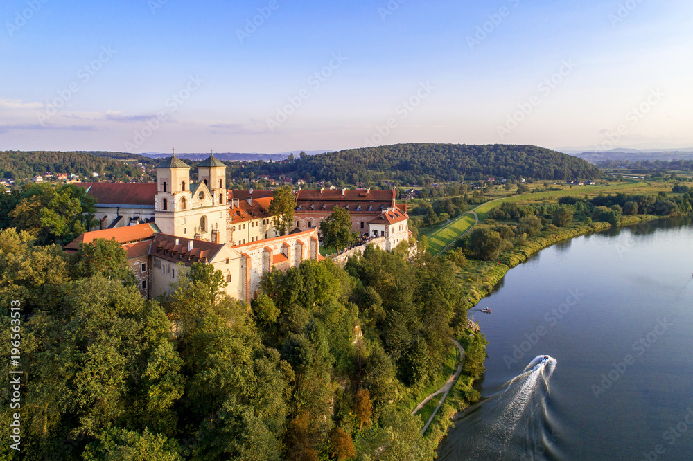 Benedictine abbey on the rocky hill in Tyniec near Cracow, Poland, and Vistula River. Aerial view at sunset
