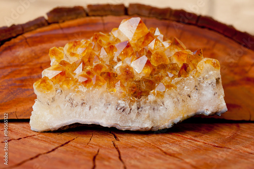 Photos Citrine crystal cluster on wooden tree stump