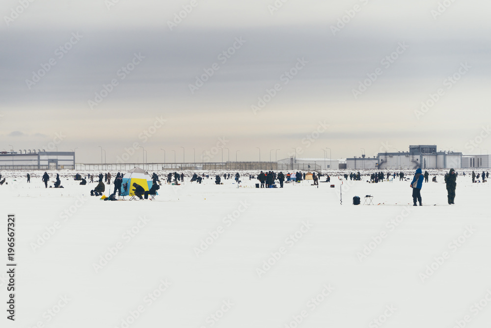 Fishermans on ice. Mans fishing on ice on gulf on Finland near Kronshtadt, Saint Petersburg, Russia,