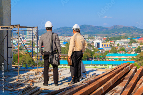 engineer consult construction site To plan development on housing High rise building