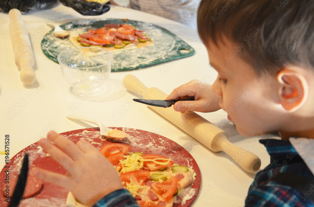 happy little boy preparing pizza happy little boy preparing pizza
