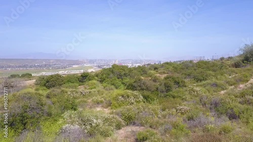 A low aerial over the mountains between Tijuana and San Diego reveals the border wall fence. photo