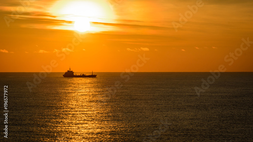 Ocean sunset and tanker on horizon © Vallehr
