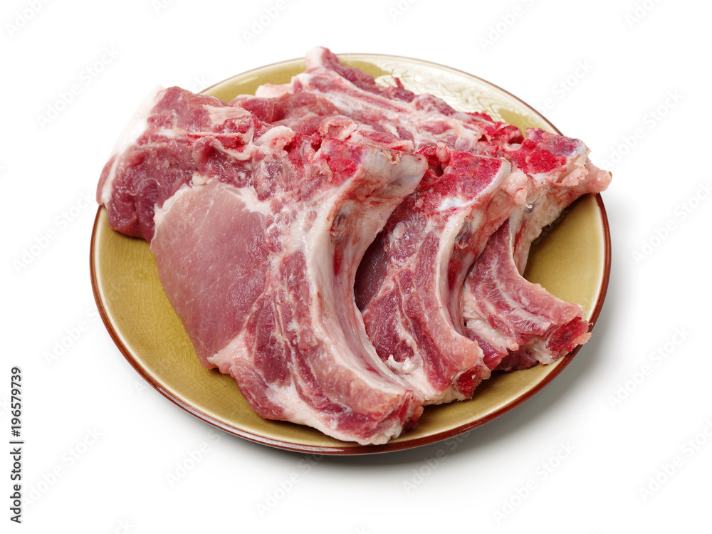 Raw pork ribs on plate isolated on whiteboard