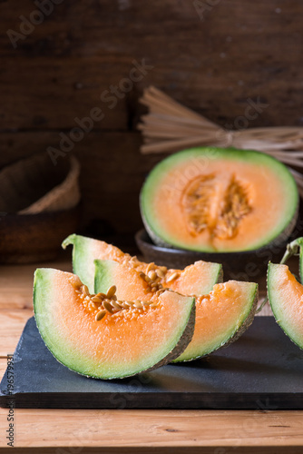 Melon slice on wooden table photo