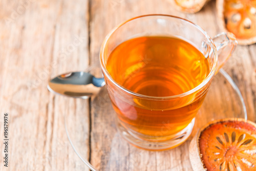 Bael tea juice on wooden table , healthy drink