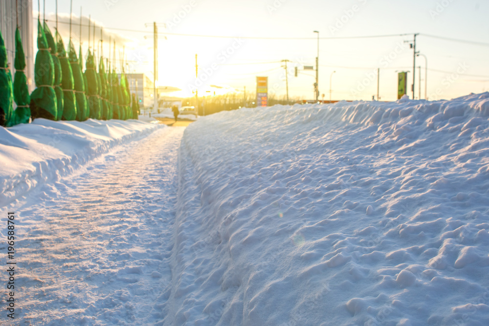 Path walking way to my home with snowy on winter season in sunset time.