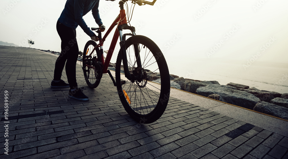 cyclist riding mountain bike on the coast cyclist riding mountain bike on the coast